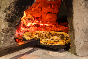 taking-pizza-out-paraguayan-handmade-oven-tatakua